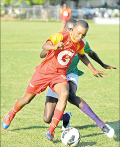 Cornwall College’s Ackeem McCarthy (foreground) gets away from William Knibb Memorial’s Brad Johnson in their ISSA/Gatorade/Digicel daCosta Cup Inter-zone game at Jarrett Park yesterday. Cornwall College won the game 4-0. (Photo: Paul Reid)